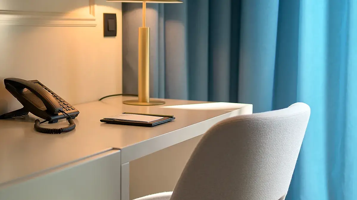 Working desk with golden lamp and telephone