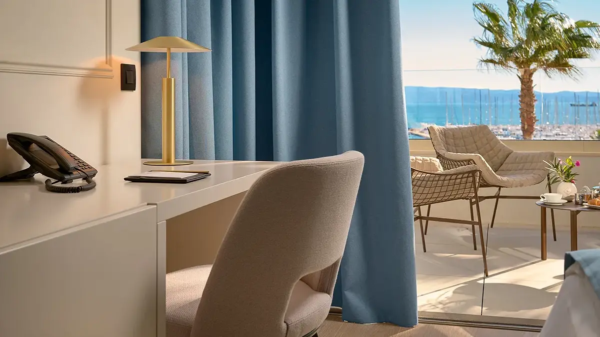 Chair and table near the balcony in a hotel room