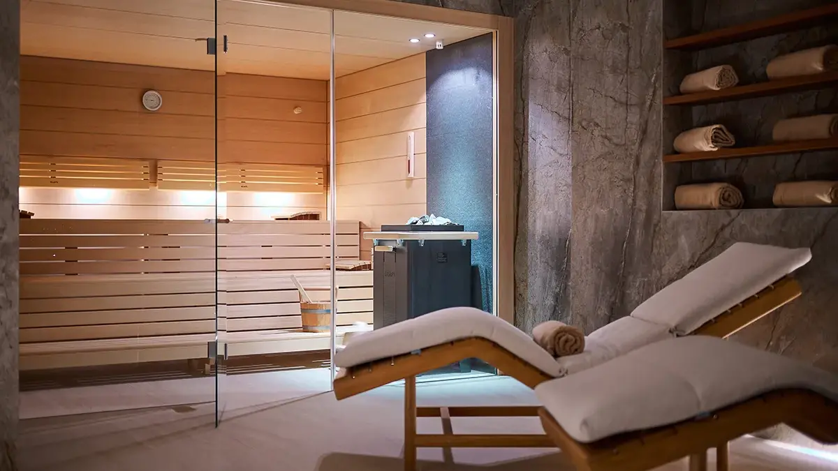 Sauna and Spa in Boutique Hotel Mirari, with comfortable wooden chairs and beige towels
