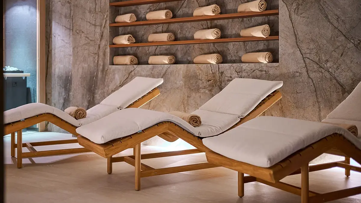 Sauna and Spa in Boutique Hotel Mirari, with comfortable wooden chairs and beige towels