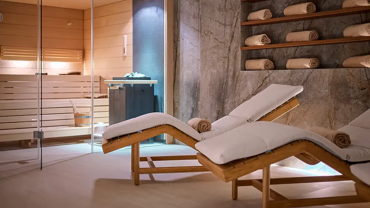 Sauna and Spa in Boutique Hotel Mirari, with comfortable wooden chairs and beige towels