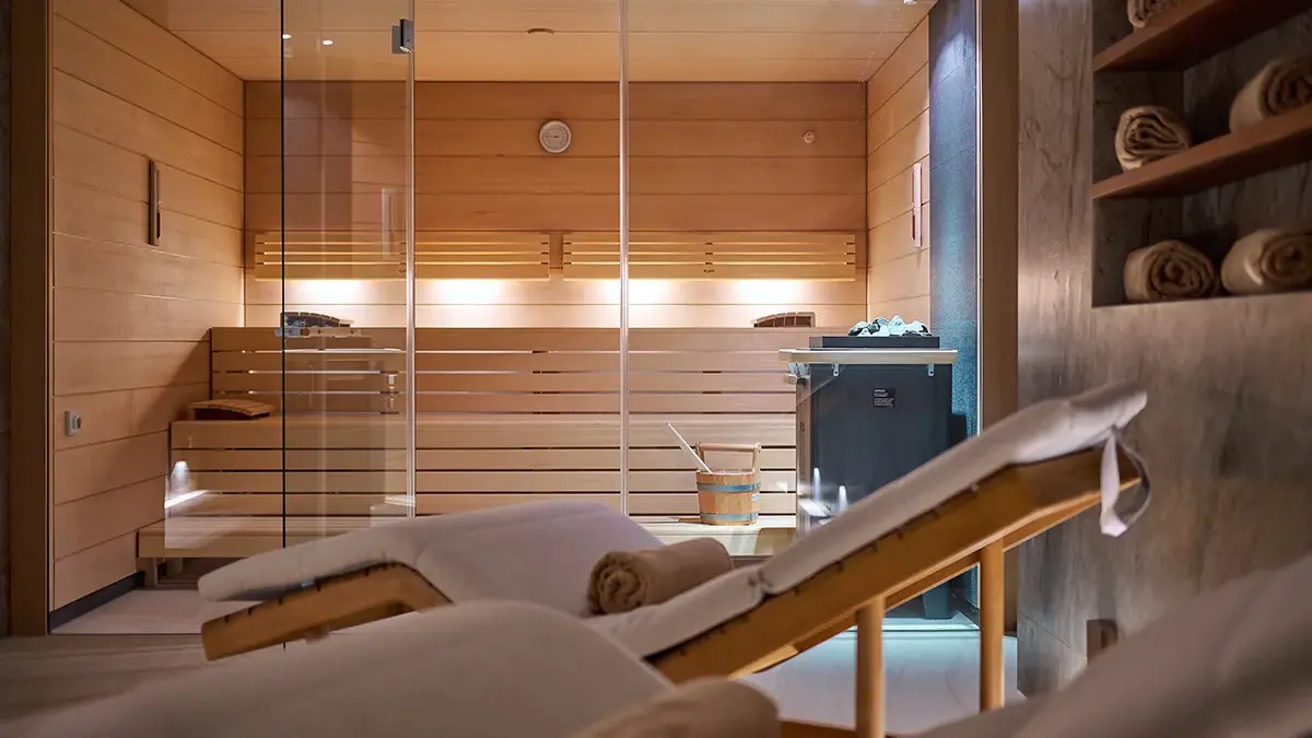 Sauna and Spa in Boutique Hotel Mirari, with comfortable wooden chairs and beige towels